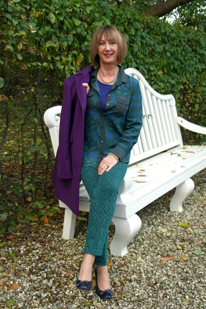A green outfit and a purple coat