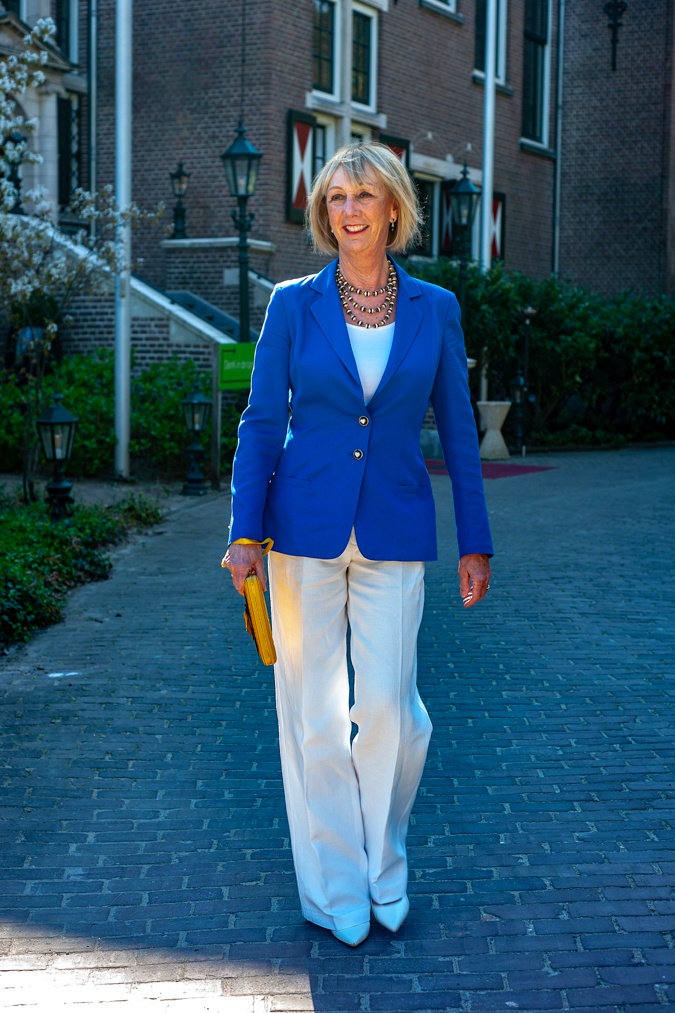 White flared trousers with a bright blue jacket