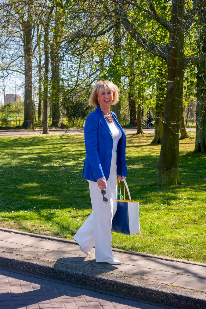 White flared trousers with a bright blue jacket