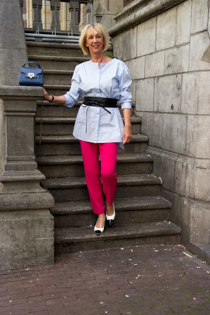 Bright pink trousers with baby blue shirt