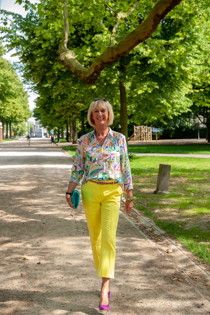 Lemon yellow trousers and a multi-coloured shirt