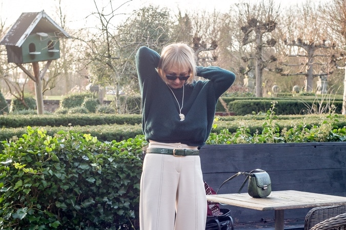 Dark green jumper with cream trousers