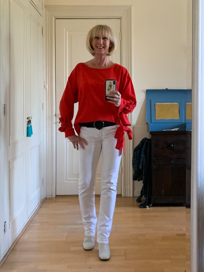 Red top on white trousers