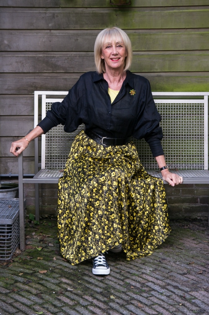 Yellow and black pleated skirt with black shirt