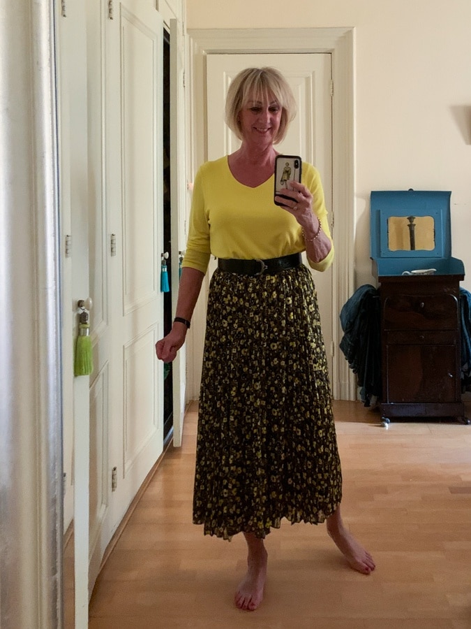 Yellow and black pleated skirt with a more form fitting jumper