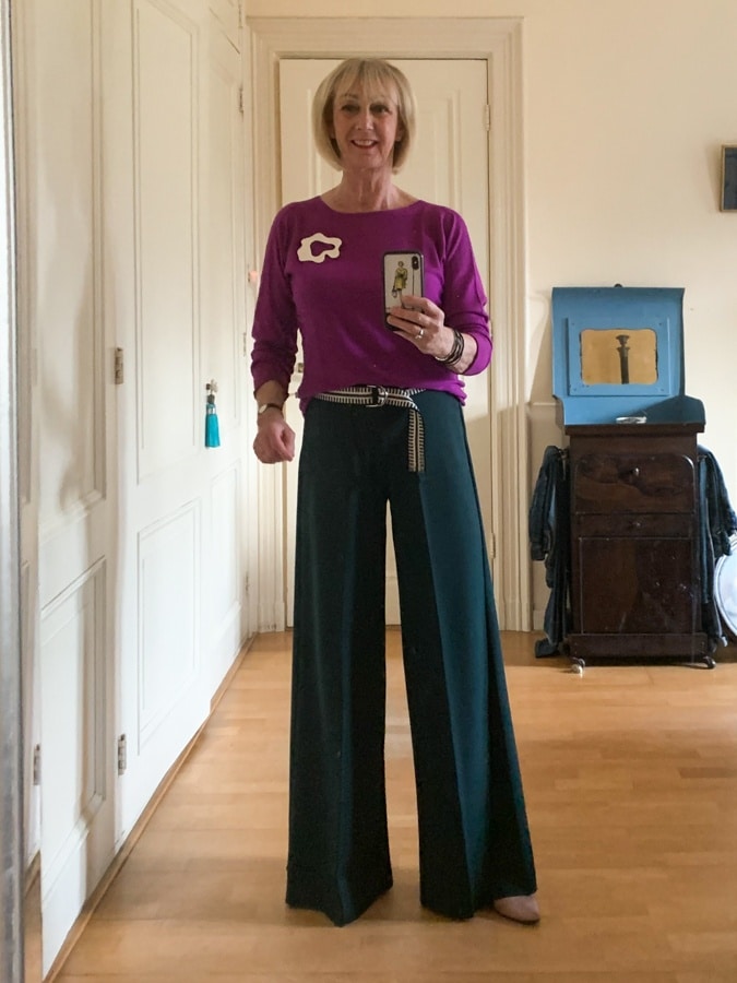 Wide green trousers with purple jumper