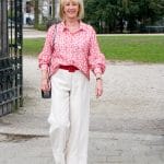 Red and cream shirt on cream trousers