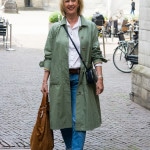 Walking through Amsterdam in a wide green trench coat