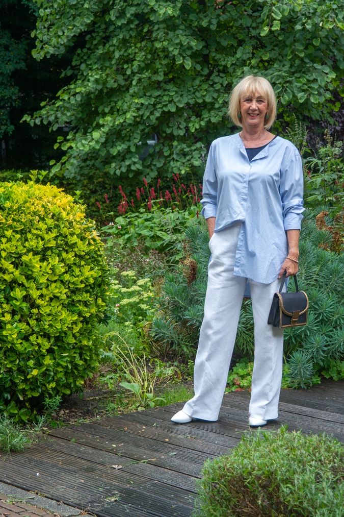 Wide white trousers styled with a blue shirt and a blue top