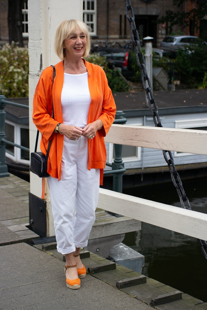 orange jacket with white trousers