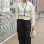 Wide black trousers with a soft yellow jumper