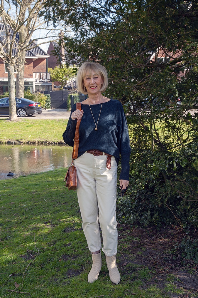 Navy blue jumper with cream trousers