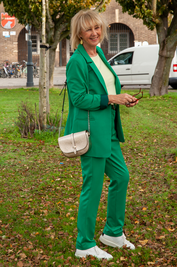 Green suit with soft yellow top and white trainers