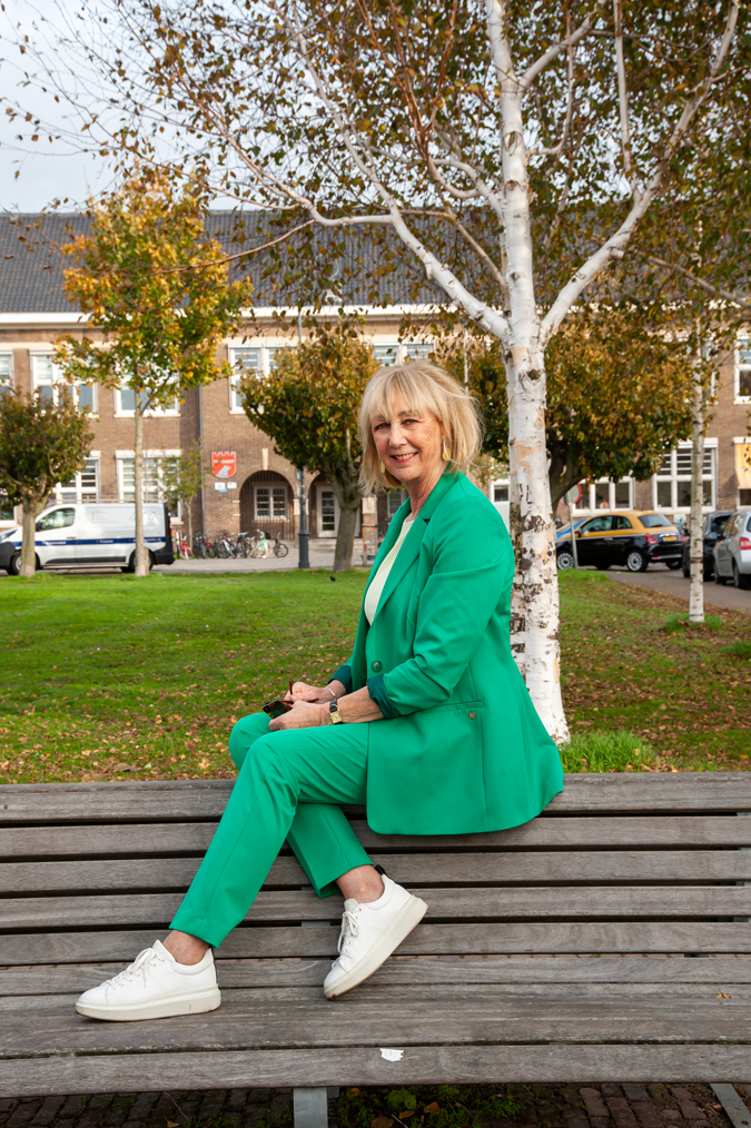 Green suit with soft yellow top and white trainers