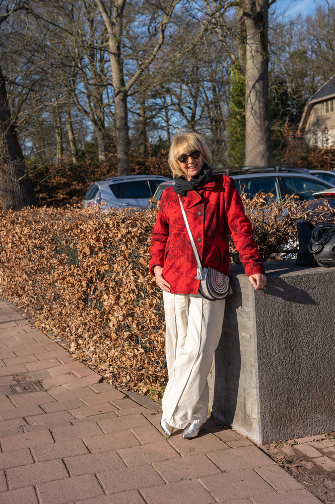 Wide cream trousers with a red jacket