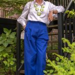 Cobalt blue trousers with a green and white necklace by Angela Caputi
