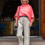 Pebble coloured trousers with a neon pink top