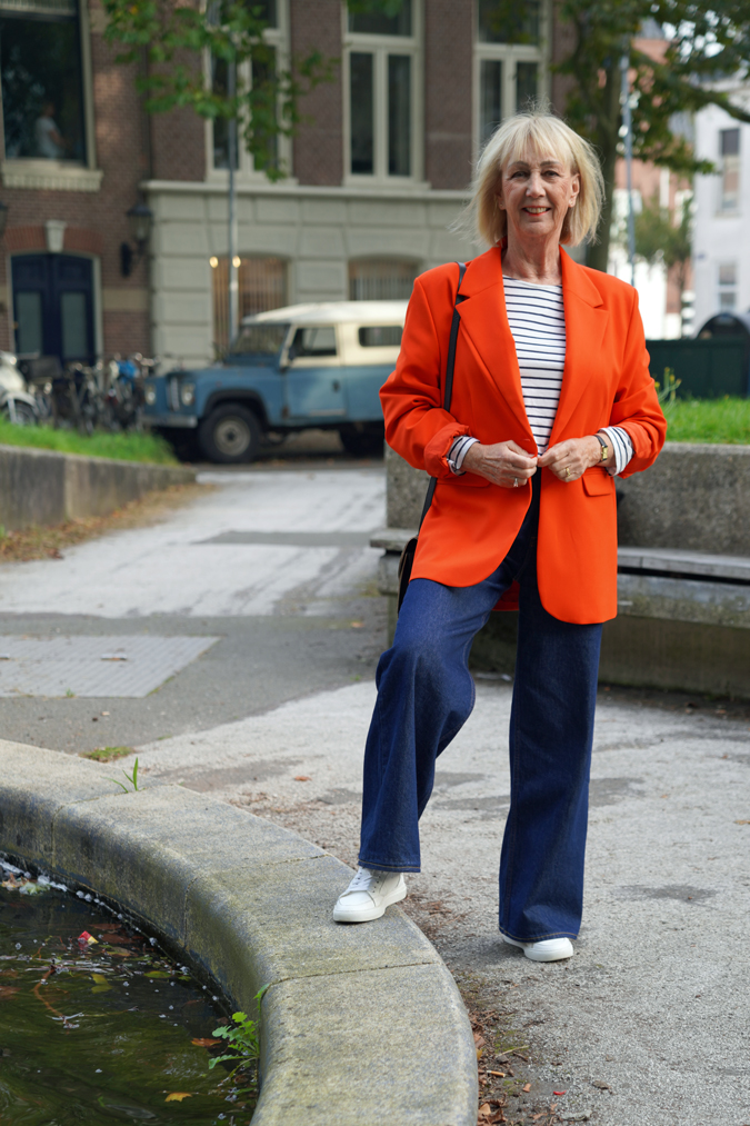 Wide leg jeans and an oversized orange blazer