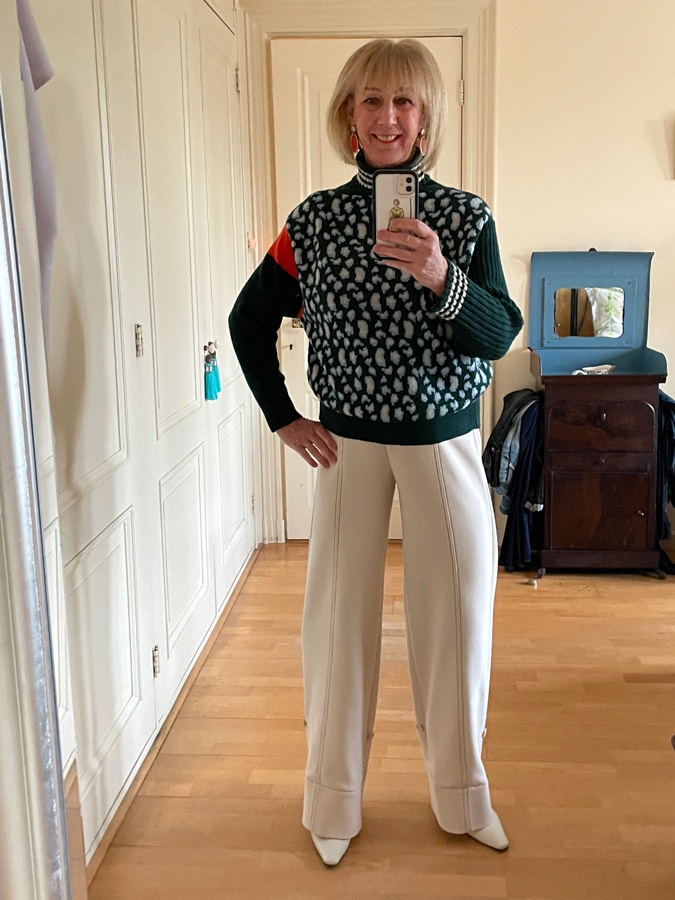 Green jumper with cream trousers