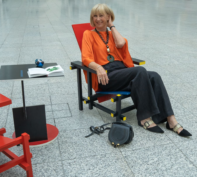 Black linen trousers with an orange top