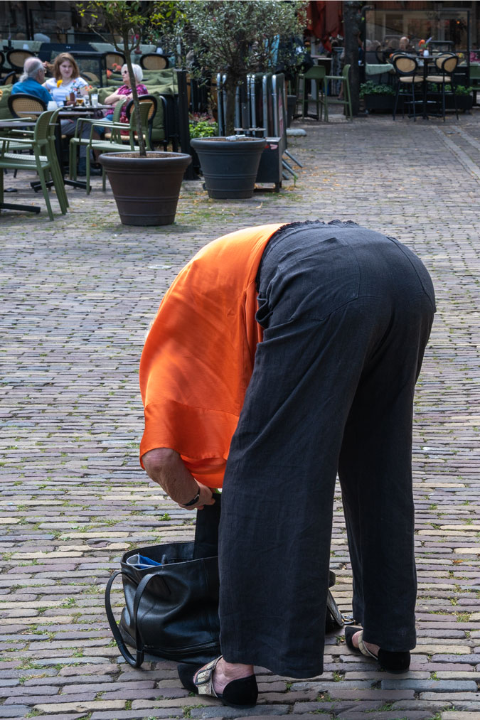 Black linen trousers with an orange top