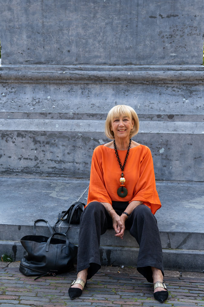 Black linen trousers with an orange top