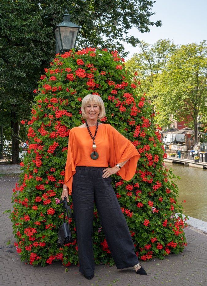 Black linen trousers with an orange top
