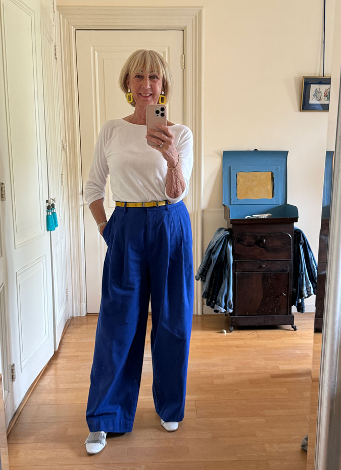 Blue trousers with white top and yellow accessories