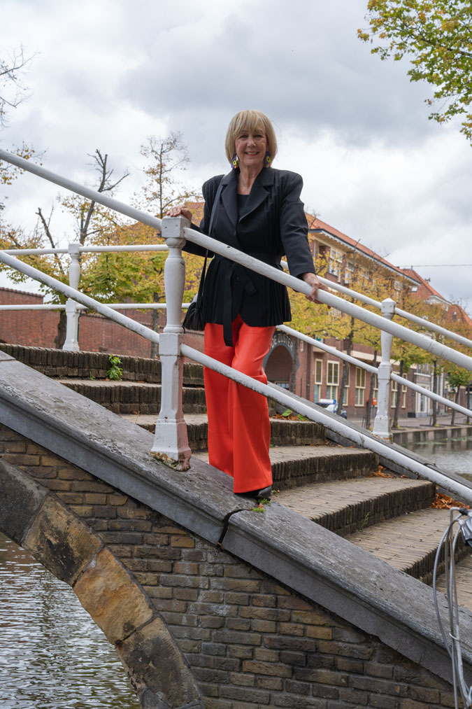 Pleated black blazer with orange pleather trousers