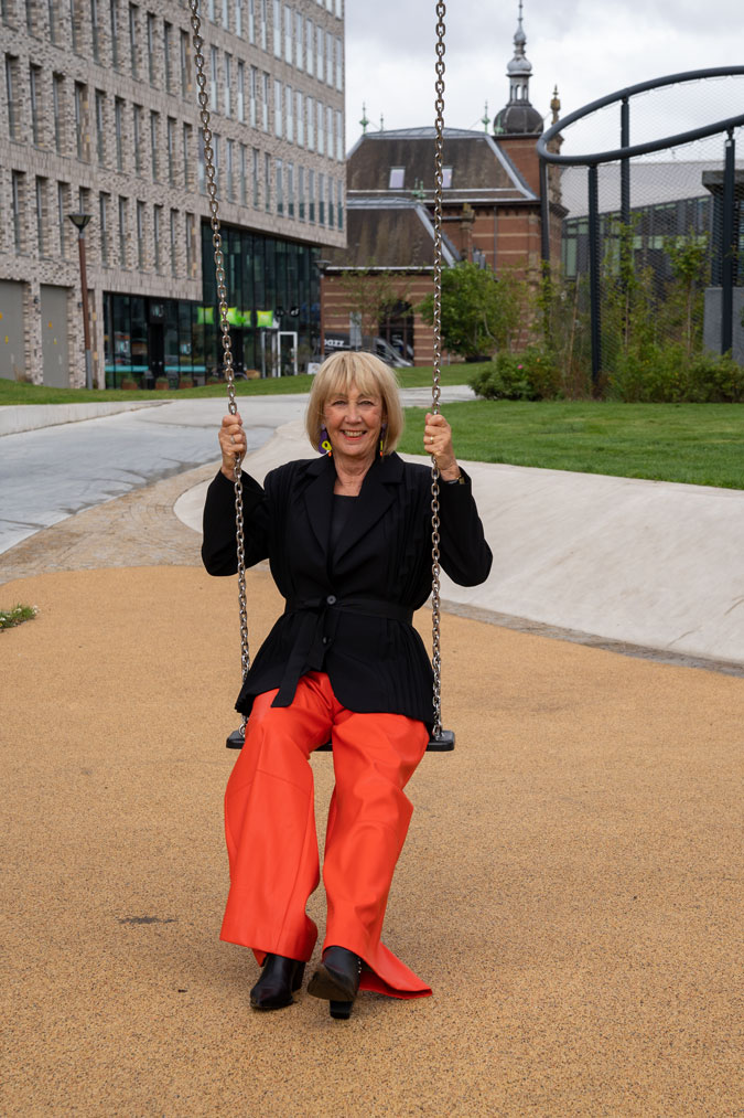 Pleated black blazer with orange pleather trousers