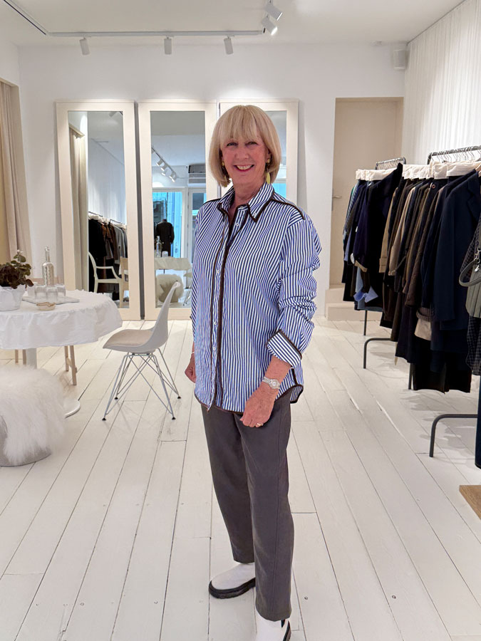 Blue and white striped shirt on brown vegan leather trousers