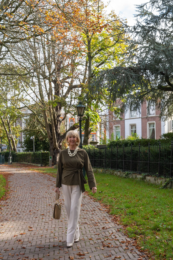 Cream trousers with a green top