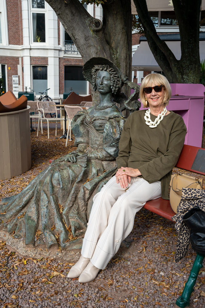 Cream trousers with a green top