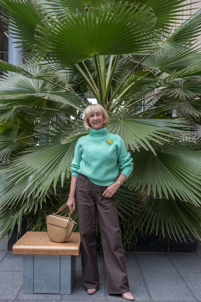 Bright green jumper with brown jeans