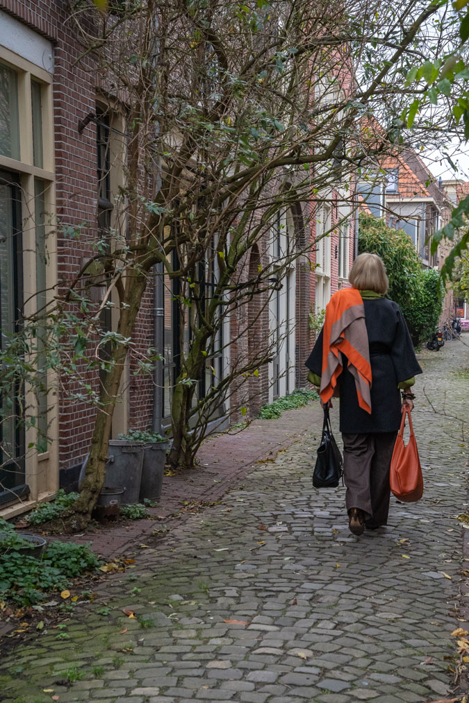 Kimono shaped coat with orange scarf from the back