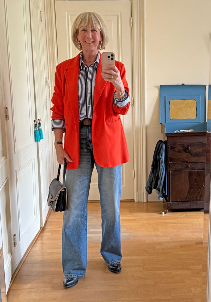 Orange blazer with a blue and white shirt and the right jeans