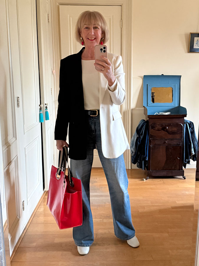 Black and cream blazer with jeans and a red tote