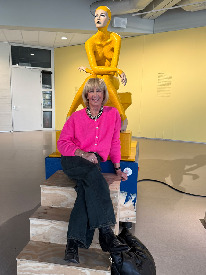 Bright pink cardigan with dark blue jeans