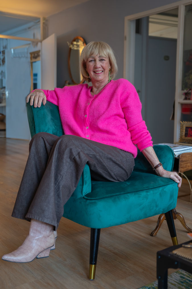 Bright pink cardigan with brown jeans