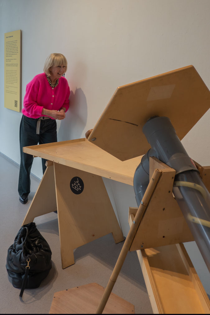Bright pink cardigan with dark blue jeans