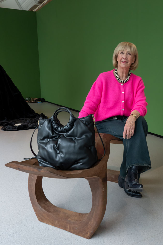 Bright pink cardigan with dark blue jeans
