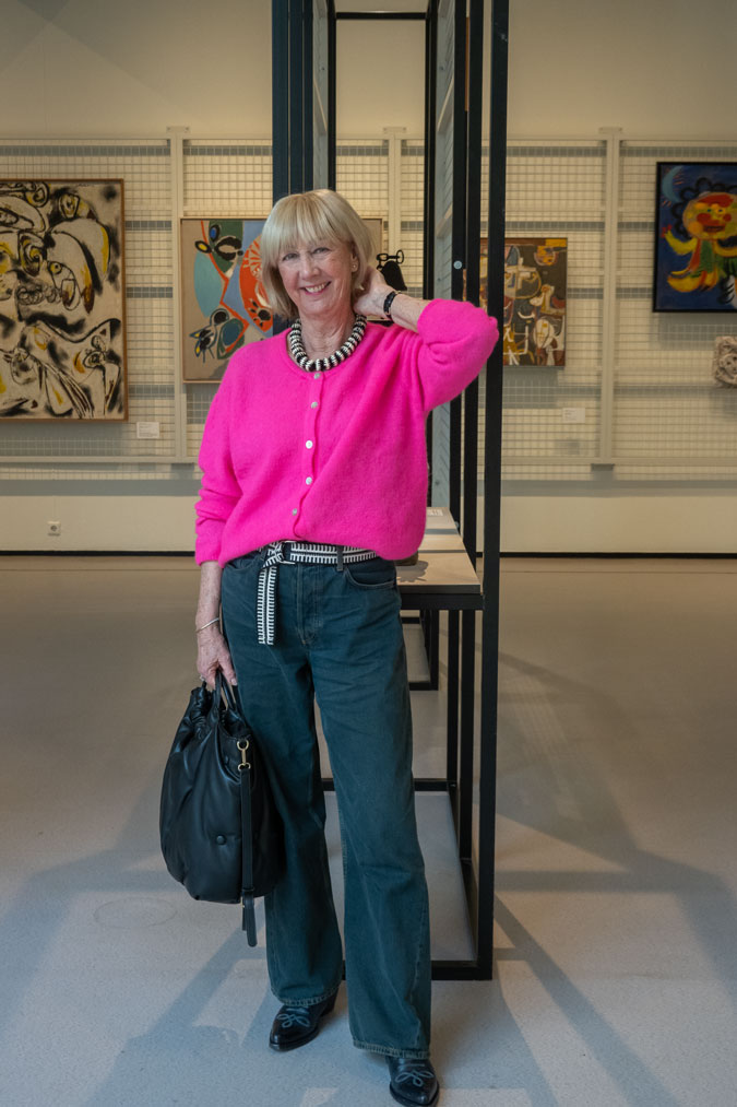 Bright pink cardigan with dark blue jeans