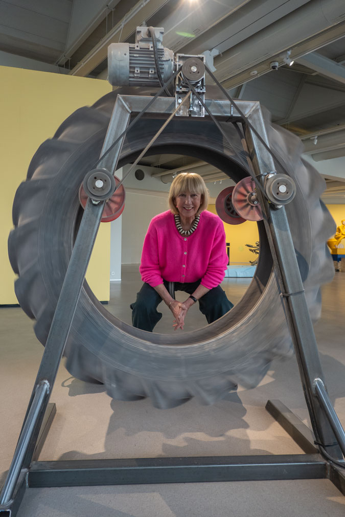 Bright pink cardigan with dark blue jeans