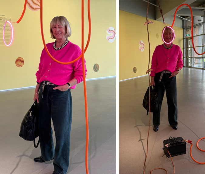 Bright pink cardigan with dark blue jeans