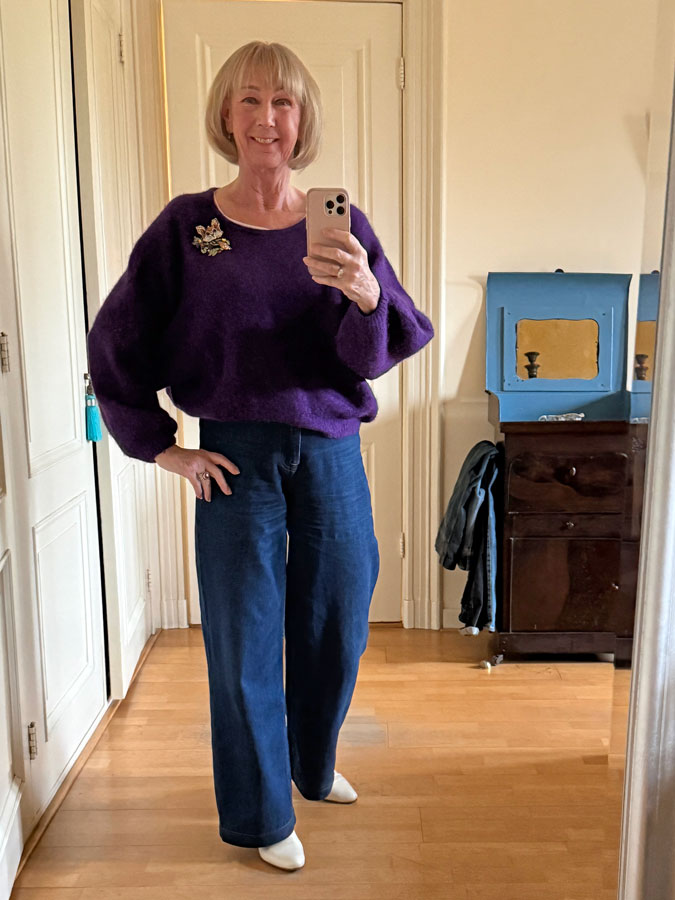 Purple jumper with jeans and a big brooch