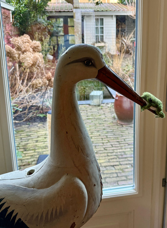 Stork ornament with frog