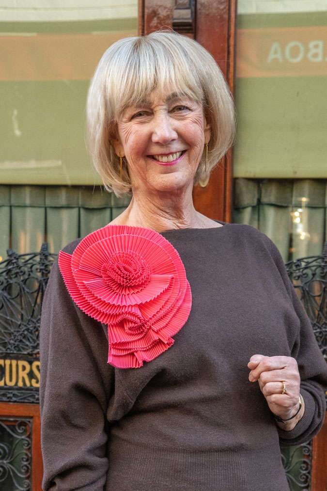 Black flared trousers with a brown jumper