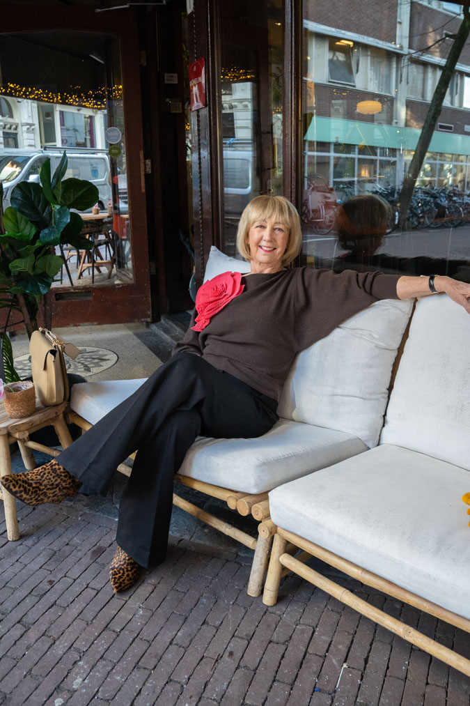 Black flared trousers with a brown jumper