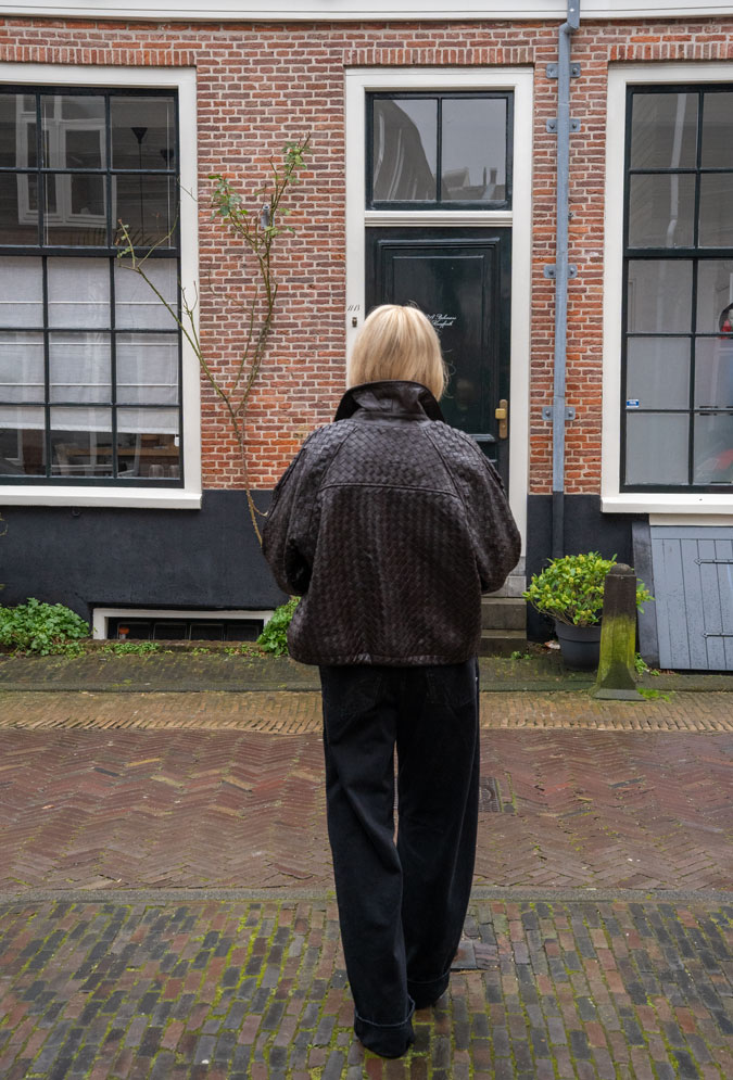The back of the brown leather jacket