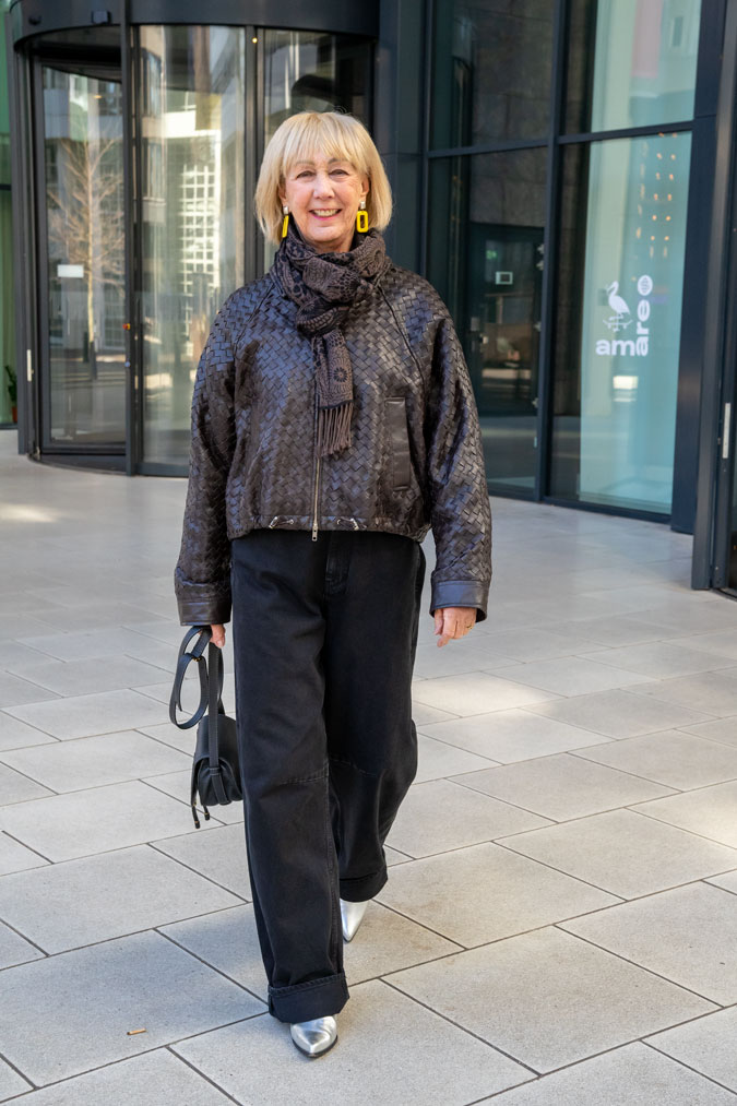 Brown leather jacket and black wide leg jeans